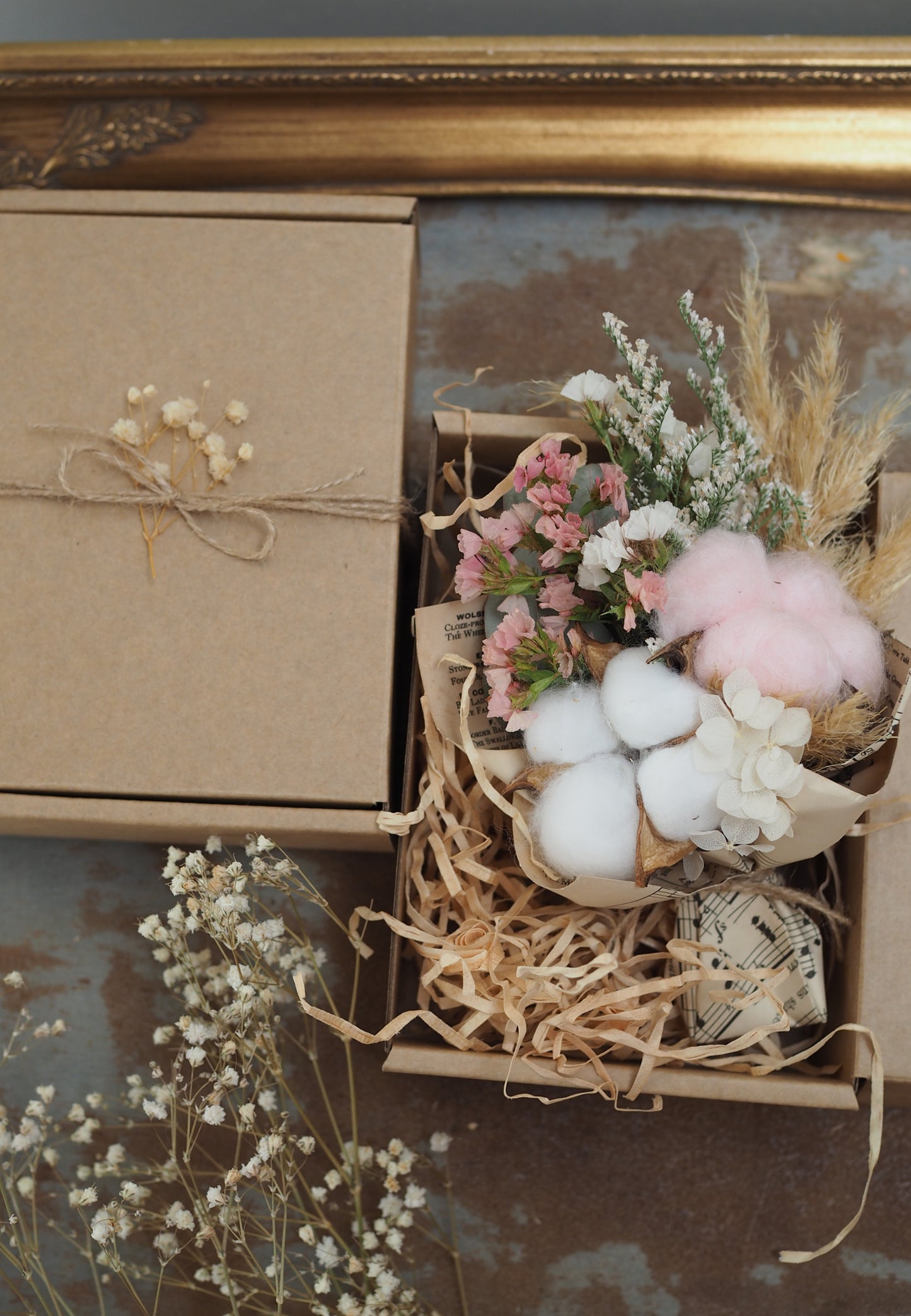 A teeny, ready-to-gift mini bouquet—just perfect for congratulations or a sweet gender reveal moment. Featuring pink or blue cotton snuggled amongst a playful mix of dried florals, each bouquet is wrapped in vintage music sheets for a touch of whimsy. Nestled inside a neutral kraft gift box to keep the colour a secret until the big surprise (Box 15 × 11.2 × 5.6 cm).