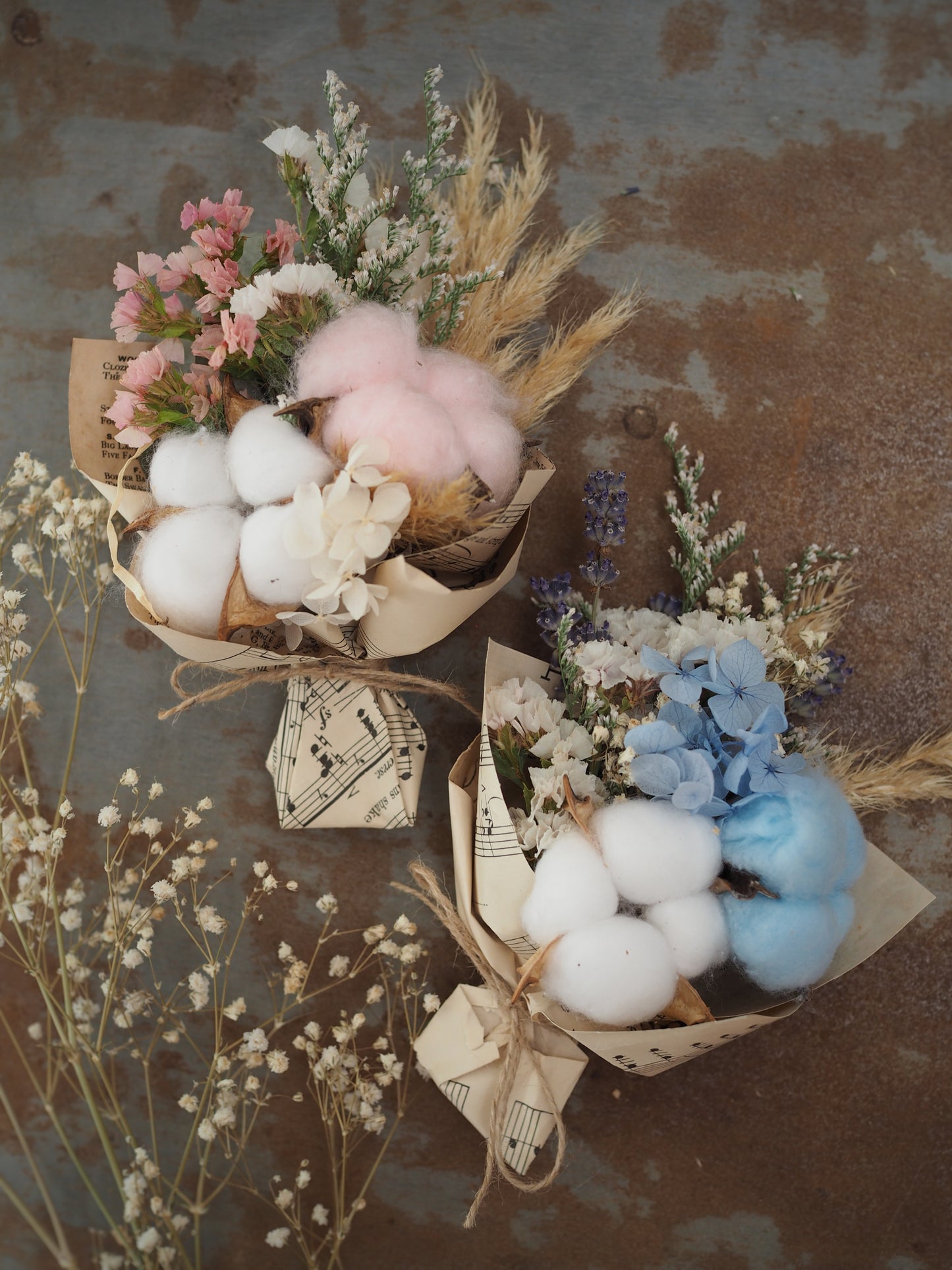 A teeny, ready-to-gift mini bouquet—just perfect for congratulations or a sweet gender reveal moment. Featuring pink or blue cotton snuggled amongst a playful mix of dried florals, each bouquet is wrapped in vintage music sheets for a touch of whimsy. Nestled inside a neutral kraft gift box to keep the colour a secret until the big surprise (Box 15 × 11.2 × 5.6 cm).