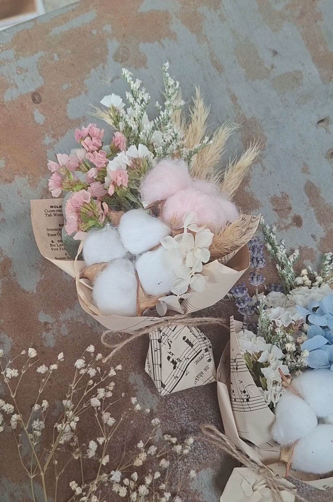 A teeny, ready-to-gift mini bouquet—just perfect for congratulations or a sweet gender reveal moment. Featuring pink or blue cotton snuggled amongst a playful mix of dried florals, each bouquet is wrapped in vintage music sheets for a touch of whimsy. Nestled inside a neutral kraft gift box to keep the colour a secret until the big surprise (Box 15 × 11.2 × 5.6 cm).