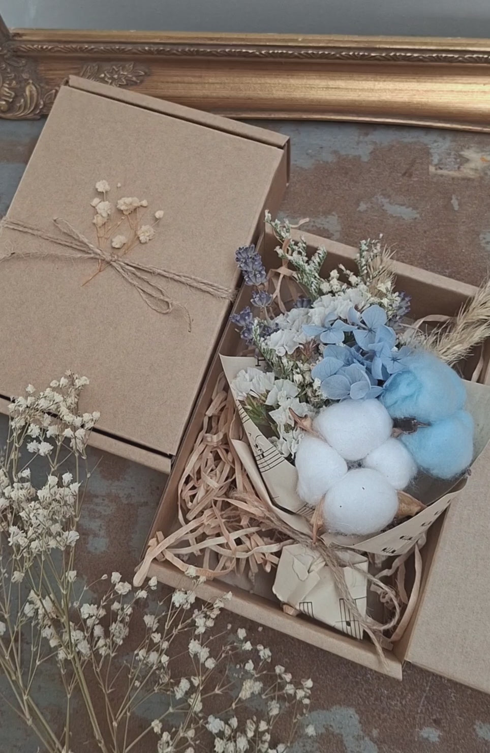 A teeny, ready-to-gift mini bouquet—just perfect for congratulations or a sweet gender reveal moment. Featuring pink or blue cotton snuggled amongst a playful mix of dried florals, each bouquet is wrapped in vintage music sheets for a touch of whimsy. Nestled inside a neutral kraft gift box to keep the colour a secret until the big surprise (Box 15 × 11.2 × 5.6 cm).